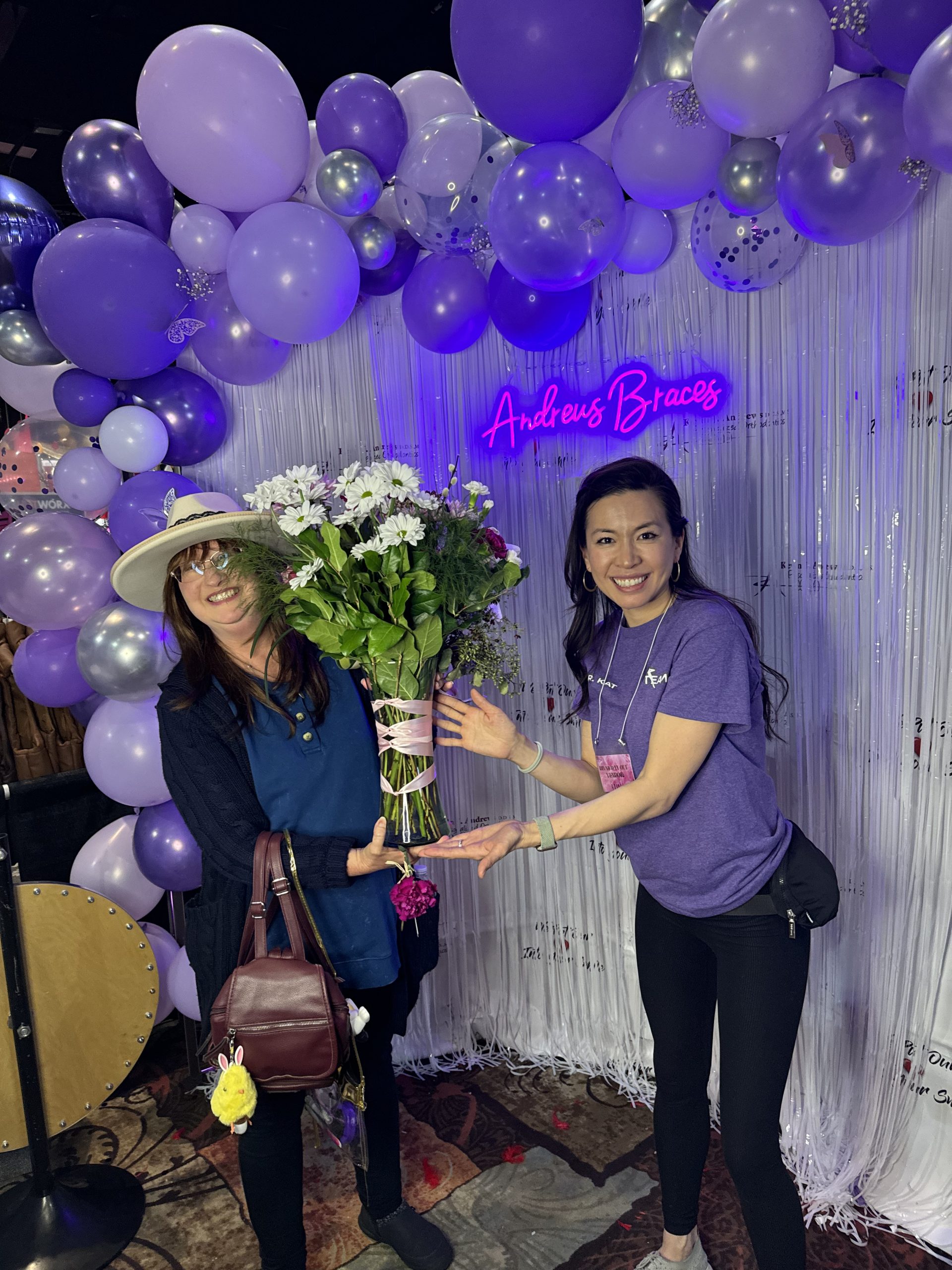 The Andrews Braces raffle winner is standing with her arrangement from Sweet Thorns Floral with Dr. Kat, a Reno-Spaarks orthodontist