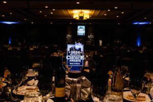 The table settin gis shown with a glowing plaque that displays the best of Reno logo