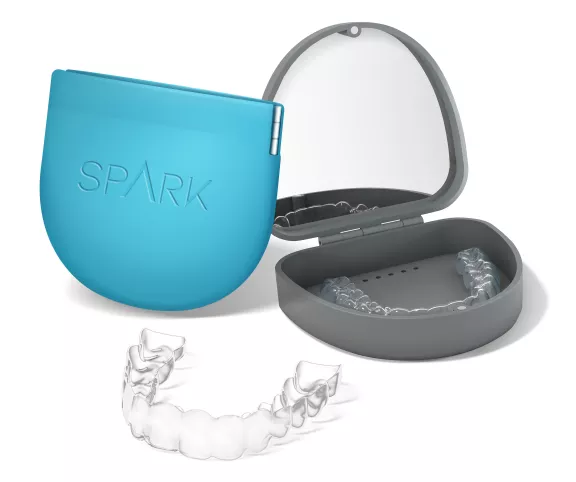 A spark clear aligner next to its case is shown